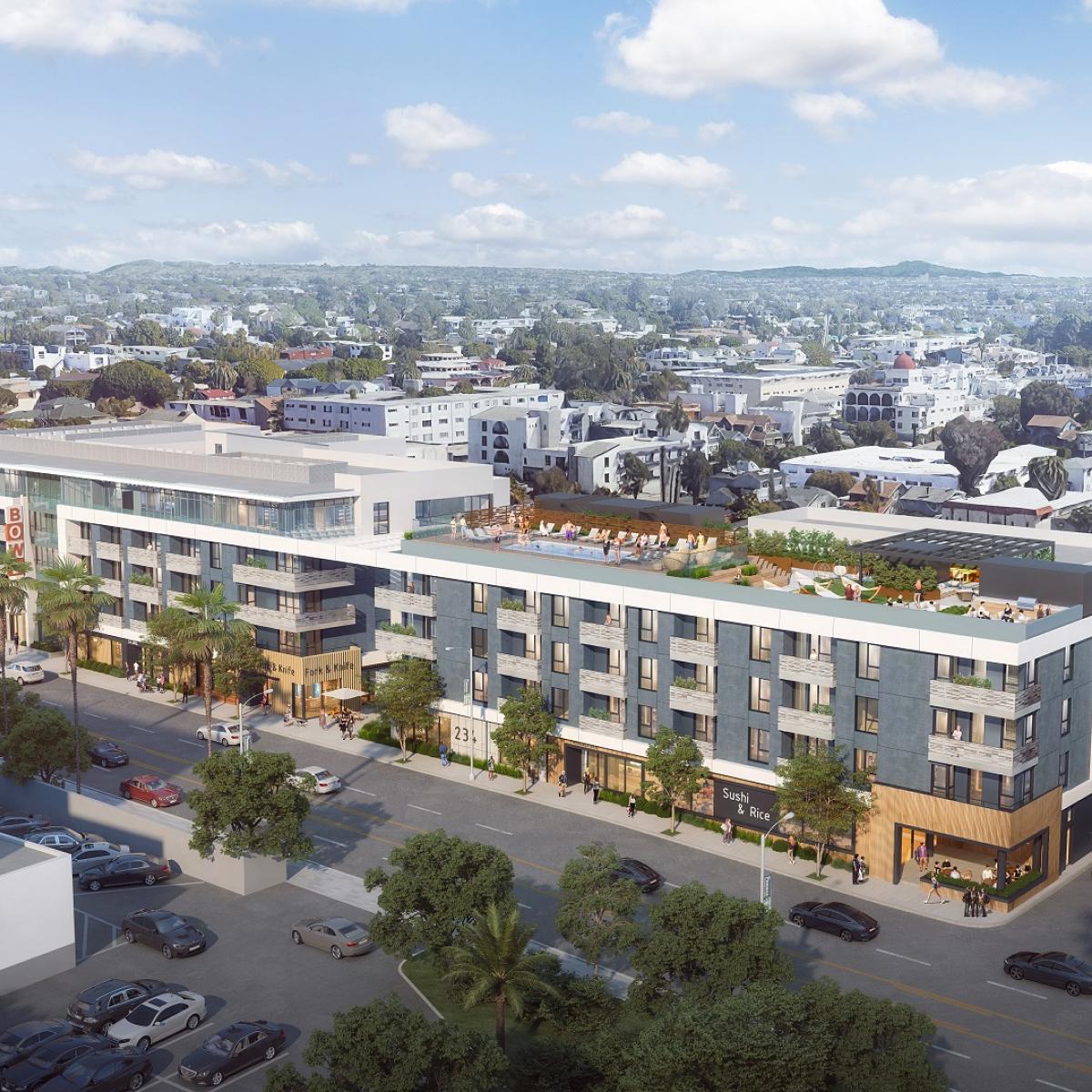 Aerial view of a mixed-use multifamily development with ground-floor retail